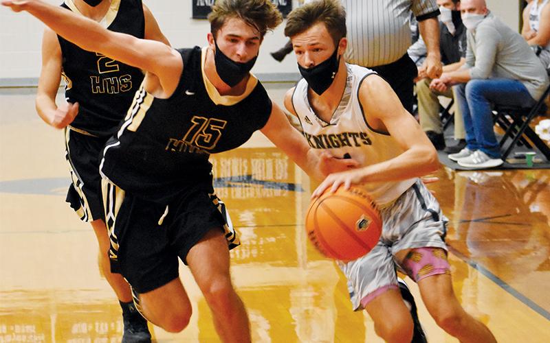Brock Adams races past Hayesville's Brady Shook on a fast break during Friday's 60-56 loss to the Jackets. Photo by Kevin Hensley/editor@grahamstar.com