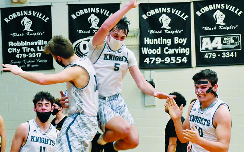 Jeb Shuler, Drey Keener, Nathan Collins and Eddie Brooms (from left) could not contain their excitement after Robbinsville bested Murphy in a 62-60 overtime thriller Tuesday night. Photos by Kevin Hensley/editor@grahamstar.com