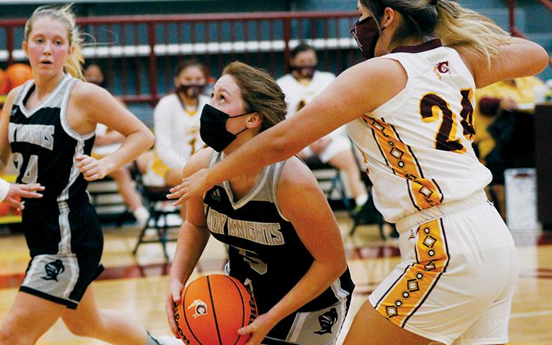 With Kensley Phillips (left) sprinting to back up the drive and Cherokee’s Praire Toineeta attempting to thwart the push, Robbinsville’s Halee Anderson eyes the basket during Friday’s 70-57 road loss to the Lady Braves. Photo by Scot McKie/Cherokee One Feather