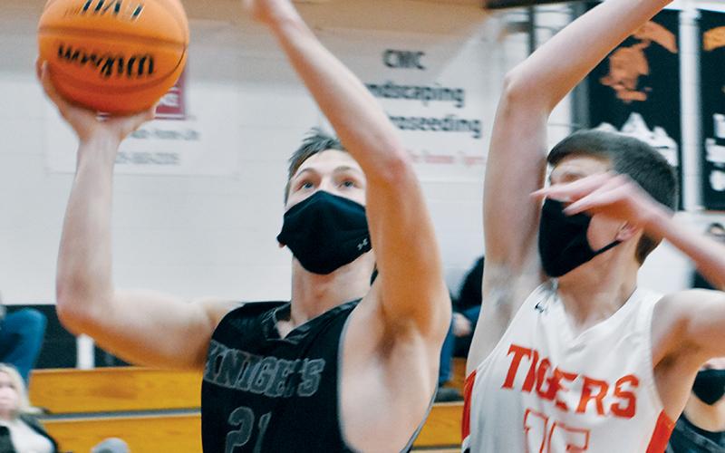 With Luke Hawk (right) closing in, Robbinsville senior Drey Keener eyes a layup Friday at Rosman. Along with Kamdyn Jordan, Keener had a team-high 14 points in the Black Knights’ 61-20 win over the Tigers. Photos by Kevin Hensley/editor@grahamstar.com