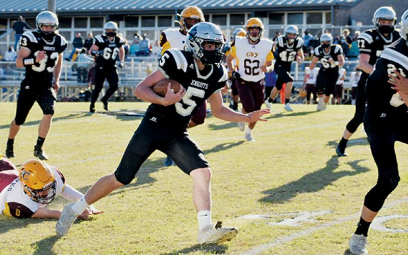 Black Knights quarterback Nathan Collins (5) leaves Cherokee’s Chase Calhoun (8) in the dust during Saturday’s home game against the Braves. Collins had two rushing touchdowns in Robbinsville’s 35-14 victory. Photo by Art Miller/amiller@grahamstar.com