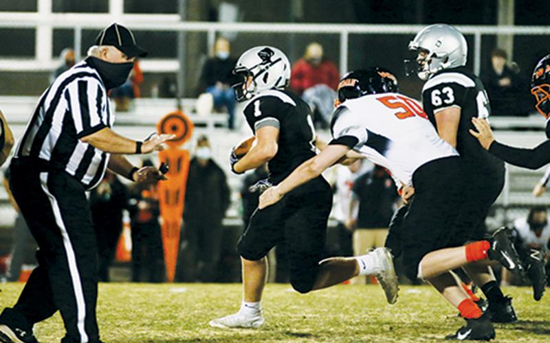 Turner Jackson (1) pulls away from some heavy Rosman pressure during Robbinsville’s 56-6 win over the Tigers on Feb. 25. Jackson emerged as the Black Knights’ leading rusher in the victory, tallying 71 yards on just five carries. Photos by Montana Buchanan/Robbinsville High School Yearbook