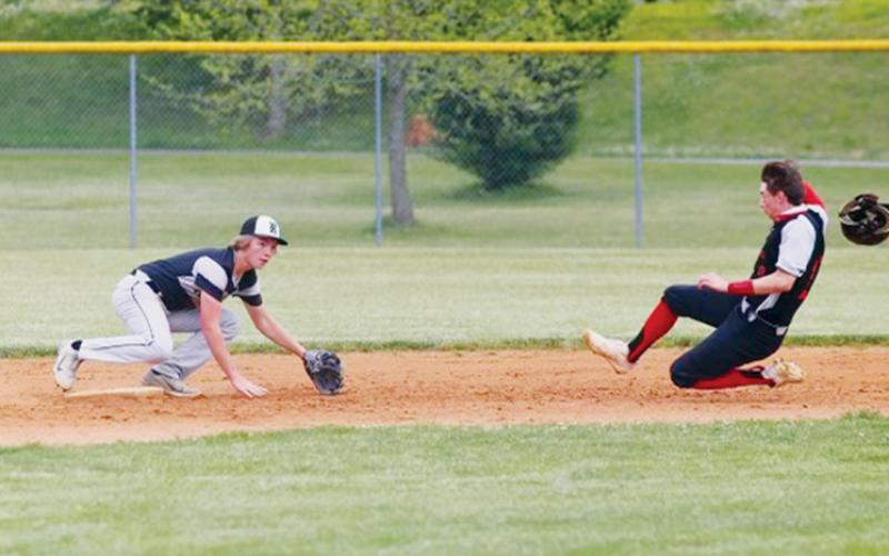 Robbinsville’s Cole Patterson crouches in preparation of thwarting Andrews’ A.J. Weaver on a stolen base attempt during May 11’s road game against the Wildcats. Photos by Miranda Buchanan/Robbinsville High School Yearbook