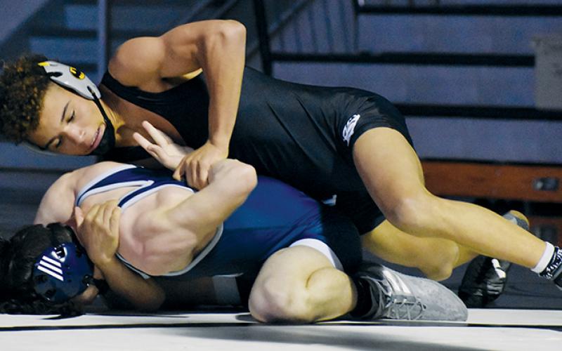 Robbinsville’s Jayden Nowell cinches in a hammerlock on Enka’s Damien Maxwell during a 132-pound bout May 15. The Knights will host the Smoky Mountain Conference tournament next week. Photo by Kevin Hensley/sports@grahamstar.com