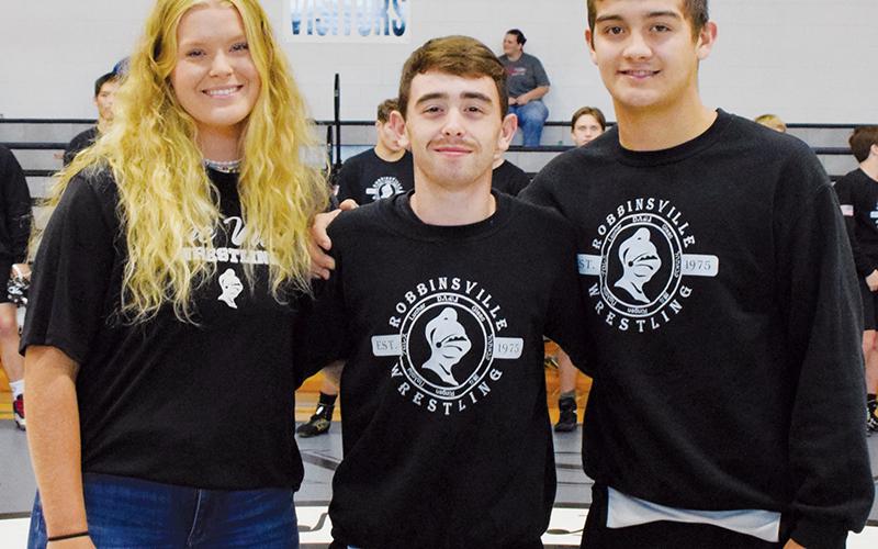 Prior to Saturday’s match against West Henderson, Robbinsville High School recognized its senior wrestling members: manager Maggie Knight, Luke Wilson and Wade Hamilton (from left). Not pictured is Simon Cody, who left on Memorial Day to enlist with the U.S. Army.
