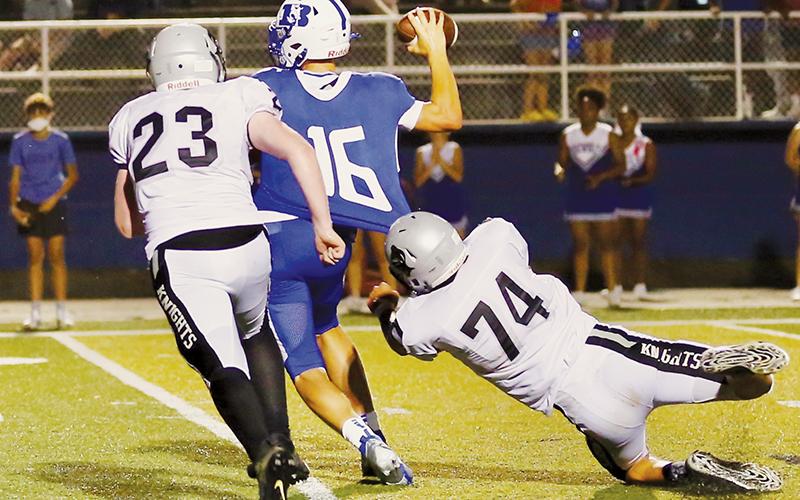Briley Tolbert (23) and Ben Wachacha (74) close in on Brevard quarterback Anson Burgess during Aug. 27’s road game. Robbinsville has not played since the 15-14 loss, but will suit up for a trip to Tennessee on Friday. Photo by Miranda Buchanan/Robbinsville High School Yearbook