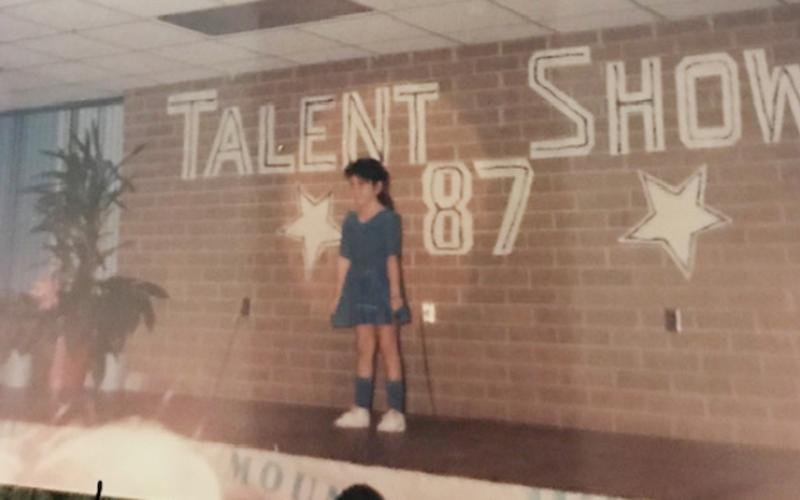 Miranda “Mandy” Millsaps (nee Seagle) was bitten by the performance bug early in life, as evidenced by this 1987 photo of her singing in a talent show.