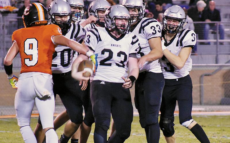 Lenoir City’s Zane Ward (9) jogs off as Robbinsville’s Dalton Hill, Eddie Brooms, Cuttler Adams, Kage Williams and Isaac Wiggins (back, from left) swarm Briley Tolbert (23), following Tolbert’s second-quarter interception Friday night. The Black Knights would pull ahead during the ensuing possession and never looked back, besting the Panthers 35-19. Photos by Kevin Hensley/sports@grahamstar.com