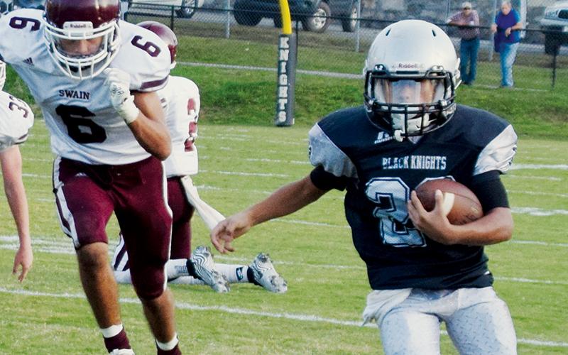Junior varsity Black Knight Adair Panama sprints away from the Swain County defense during the Oct. 14 season finale. Photo by Art Miller/amiller@grahamstar.com