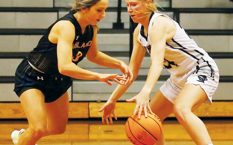 Robbinsville junior Kensley Phillips swats the ball away from Highlands’ Beatrice Bryson during Tuesday’s season opener. Phillips’ defense played a key role in the Lady Knights’ 59-39 win over the Lady Highlanders. Photo by Miranda Buchanan/Robbinsville High School Yearbook