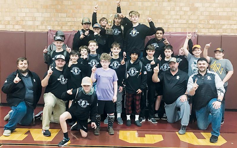 Members of the Robbinsville Middle School wrestling program celebrate the Knights’ 2021-22 Smoky Mountain Conference tournament championship, after the team clinched the crown Dec. 15 at Swain County. Photo courtesy of Crystal Hooper/Contributing Photographer