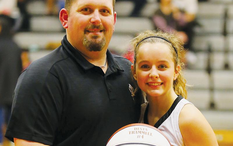 Junior point guard Desta Trammell scored her 1,000th career point Tuesday night against Swain County. Robbinsville head coach Lucas Ford presented Trammell with a commemorative ball after the game. Photo by Miranda Buchanan/Robbinsville High School Yearbook