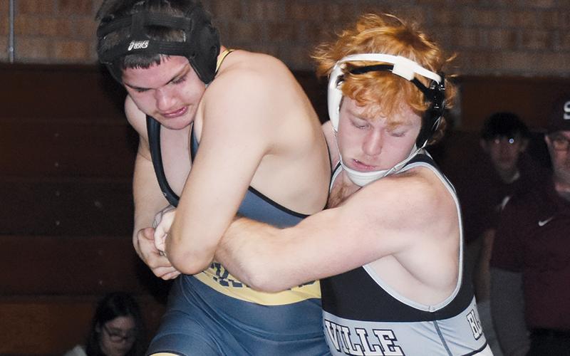 Jacob Hall hooks the leg of Hayesville’s Daniel Austin and muscles him to the mat during Saturday’s 170-pound finals.