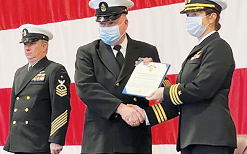Navy Reserve Senior Chief Petty Officer Jerry Crisp, center, receives his third Navy/Marine Corps Achievement Medal during his retirement ceremony in Knoxville, Tenn., on Sunday.