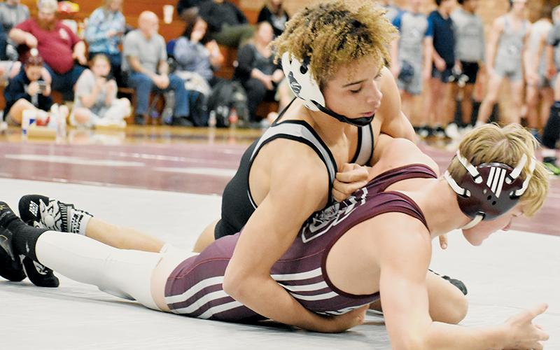 Robbinsville senior Jayden Nowell hooks the left arm of Swain County’s Owen Craig during the 132-pound bout of the Feb. 2 third round, dual-team championship match in Bryson City. Photo by Kevin Hensley/sports@grahamstar.com