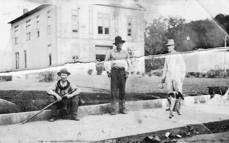 Charles Zachery Denton, Lloyd Jackson and Arthur Rogers (left) pause in front of the old wood courthouse in Robbinsville.