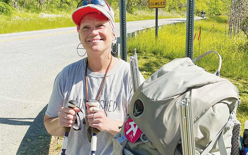 Kelly Karr poses at Stecoah Gap in Graham County on May 5 during a break in her 2,190-mile hike on the Appalachian Trail. Photo by Randy Foster/news@grahamstar.com