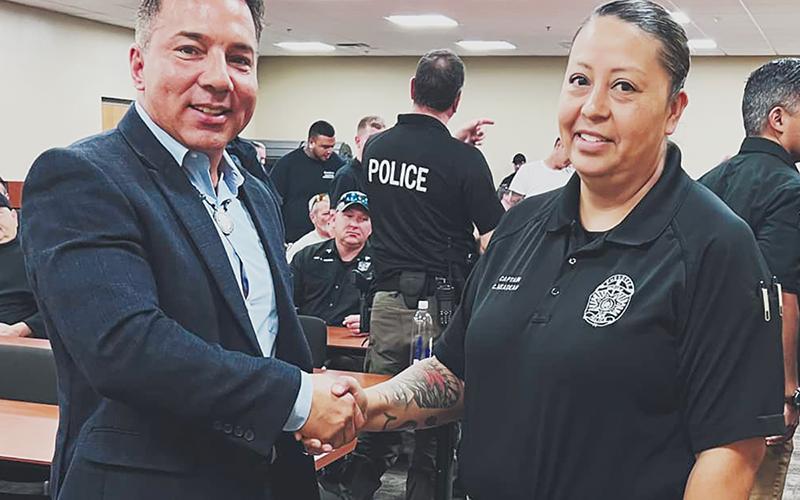 Richard Sneed, principal chief of the Eastern Band of Cherokee Indians (left) congratulates Capt. Carla Neadeau on her appointment as interim chief of police for the Cherokee Indian Police Department.