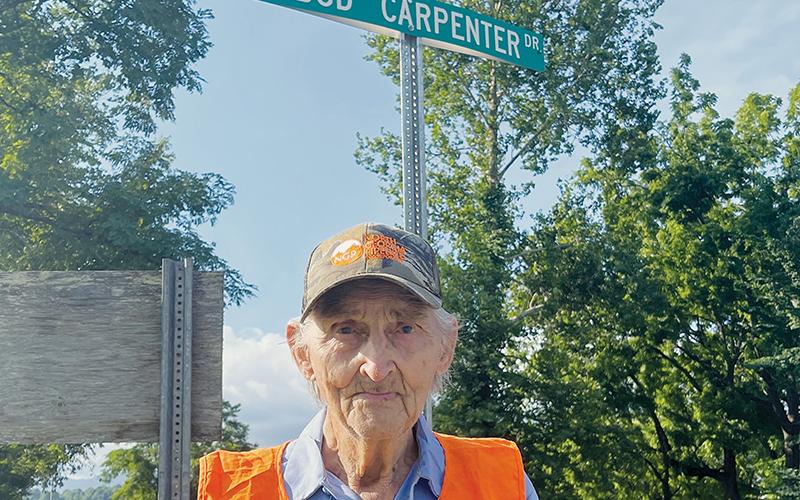 Town of Robbinsville employee Bud Carpenter stands at the intersection of Rodney Orr Bypass and Bud Carpenter Drive. The previously-unnamed private street, which leads to the town’s maintenance yard, was named in his honor about four years ago. At age 95, Carpenter is one of the oldest municipal employees anywhere. Photos by Randy Foster/news@grahamstar.com