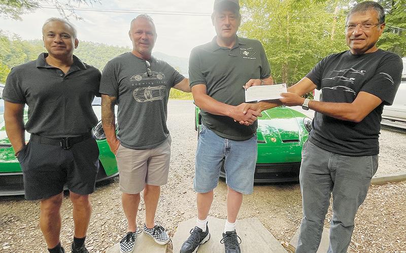 Jay Patel of Jonesboro, Ga., Chris Meaker of Charlotte, Jeff Millsaps of Graham County Rescue Squad and Mayur Malde of Sewanee, Tenn. (from left) attend a check presentation at Blue Waters Resort on Lake Santeetlah on Saturday. The group, Smokies GT, donated $5,000 to the rescue squad. Photo by Randy Foster/news@grahamstar.com