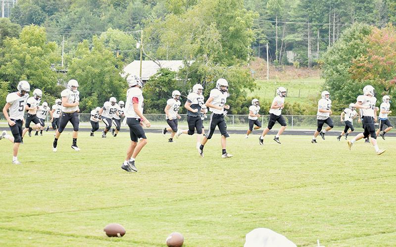 Members of the Robbinsville Black Knights begin pre-practice warm-ups Tuesday. Robbinsville kicks off the season Friday at Asheville High School. Photos by Kevin Hensley/sports@grahamstar.com