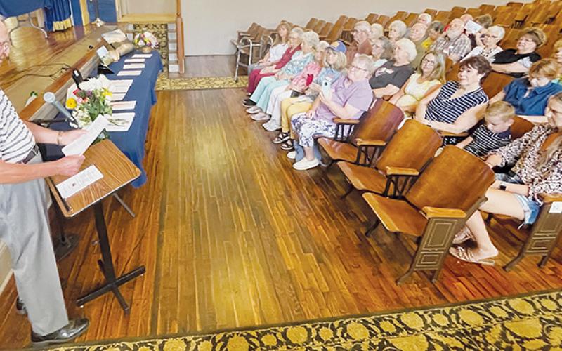 Stecoah Union School alumni C.E. Holder (left) presides over a memorial service at the annual school reunion Saturday, for the seven classmates who have passed away since last year’s reunion.