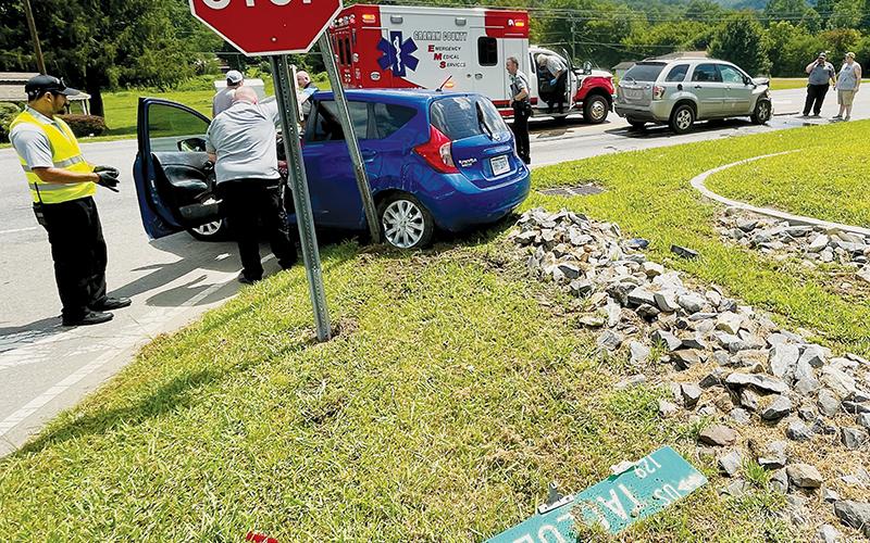 Emergency personnel attend to Martha Carpenter, whose car was involved in a collision at the intersection of Woodland Heights Road and Tallulah Road (U.S. Hwy. 129) around noon July 28. Photo by Randy Foster/news@grahamstar.com