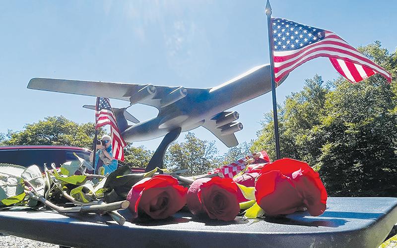 A model of a C-141B cargo jet sits on a pedestal amid roses and U.S. flags distributed to surviving family members of the crew of nine Air Force servicemen killed in a crash on Aug. 31, 1982, at a memorial service held on the 40-year anniversary of the tragedy. Photos by Randy Foster/news@grahamstar.com