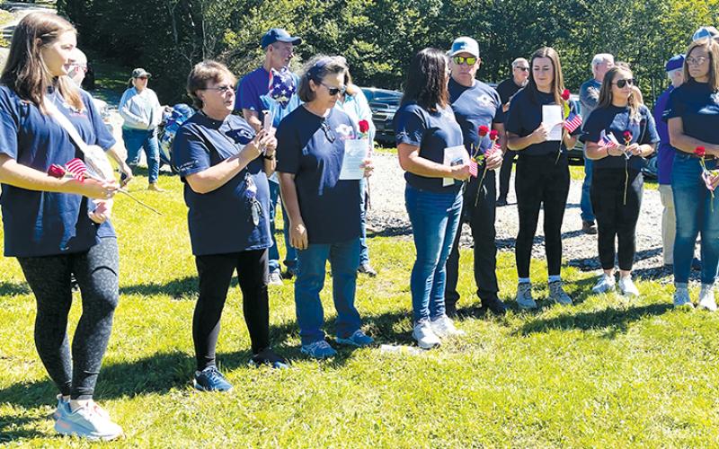 Surviving family members of the crew of nine U.S. Air Force servicemen killed in a crash on Aug. 31, 1982 – all wearing commemorative shirts – participate in a memorial service near the crash site on on the 40th anniversary of the tragedy.