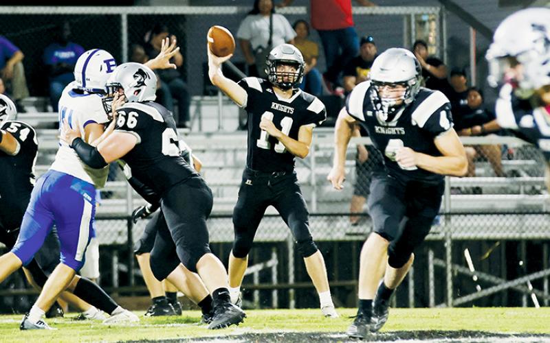 With Haden Key (66) holding off a Brevard defender – and both Cuttler Adams (4) and Brock Adams (2) breaking upfield, quarterback Donovan Carpenter aims a pass as part of Friday’s home opener against the Blue Devils. Robbinsville picked up its first win of the season in the rematch from last year’s loss. Photos courtesy of Miranda Buchanan/Robbinsville High School Yearbook