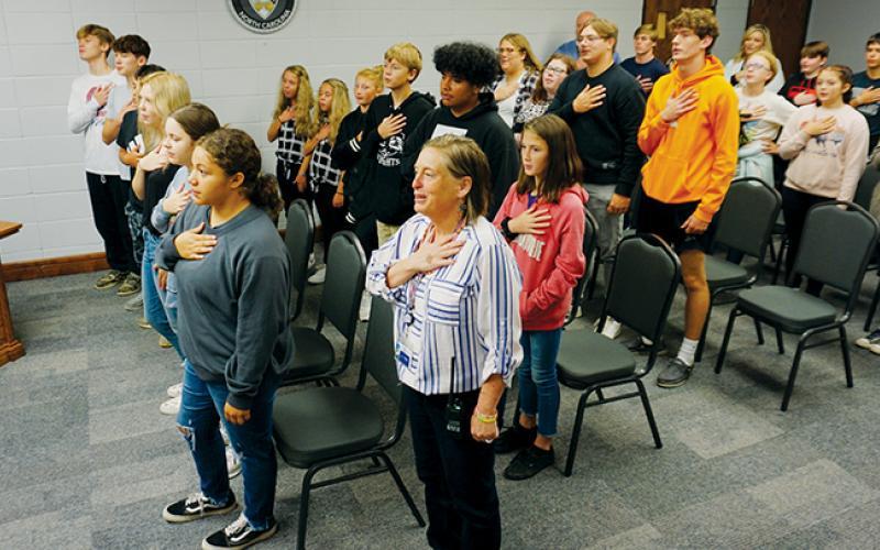 Almost two dozen members of the Noble Knights, a group that looks out for the welfare of fellow students, leads the Graham County Board of Education in the Pledge of Allegiance at the board’s meeting on Tuesday. Photo by Randy Foster/news@grahamstar.com
