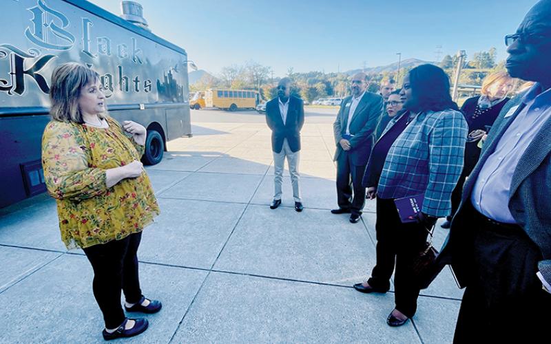 Graham County Schools Superintendent Angie Knight (left) shows representatives from Blue Cross NC Robbinsville High School’s Black Knights mobile food truck on Friday. Among Blue Cross NC officials were Dr. Tunde Sotunde, a pediatrician who is president and CEO of Blue Cross NC (center). Photo by Randy Foster/news@grahamstar.com