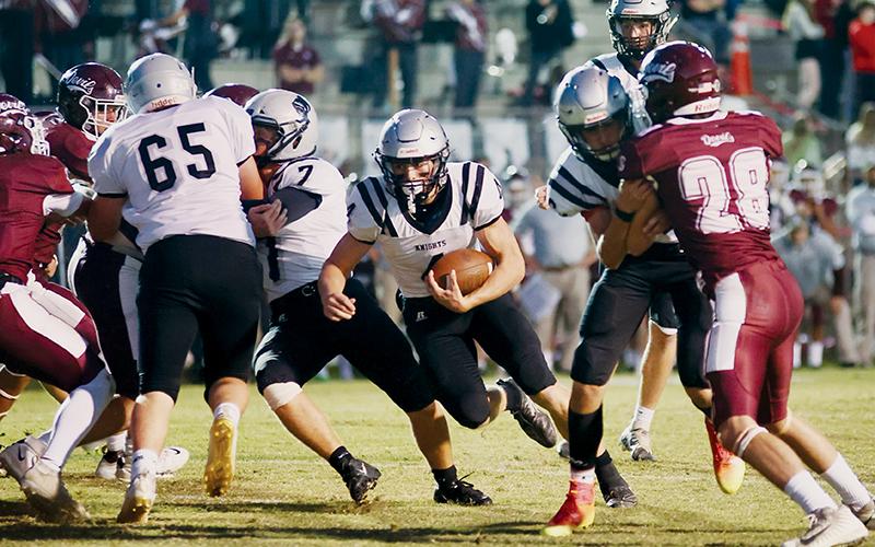 Cuttler Adams slices through a jostle at the line during the Sept. 29 conference opener at Swain County. Adams was responsible for all of Robbinsville’s scoring in the Knights’ win over the Maroon Devils. Photo by Miranda Buchanan/Robbinsville High School Yearbook