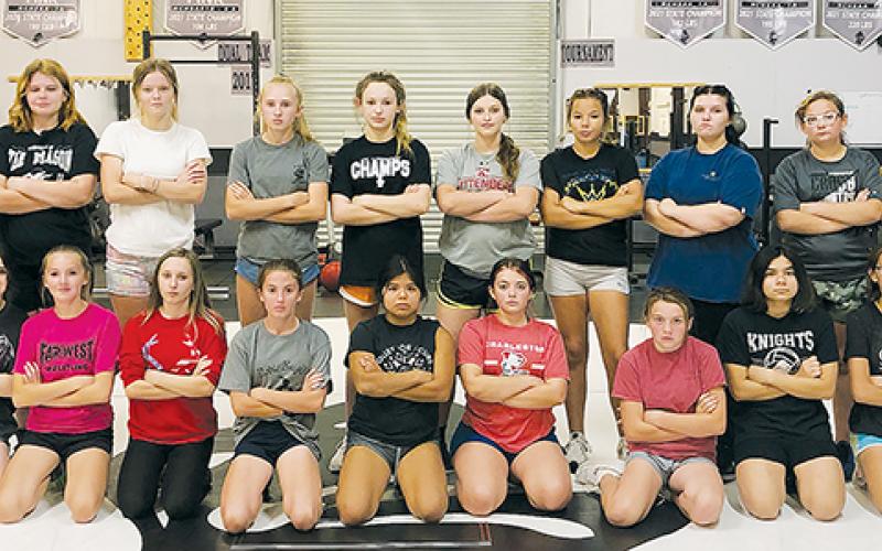 The Robbinsville wrestling program is adding another chapter to its historic legacy: the first-ever Lady Knights team, comprised of girls from Robbinsville Middle School. The coaches are Josh Winfrey (far left) and Sarah Orr (far right).