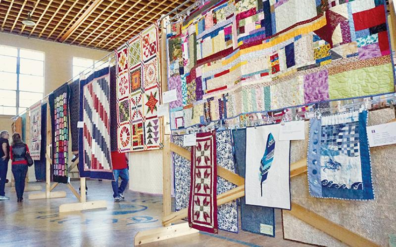 Visitors get a look at some of the many quilts on display Saturday at the Stecoah Harvest Festival. Photos by Randy Foster/news@grahamstar.com
