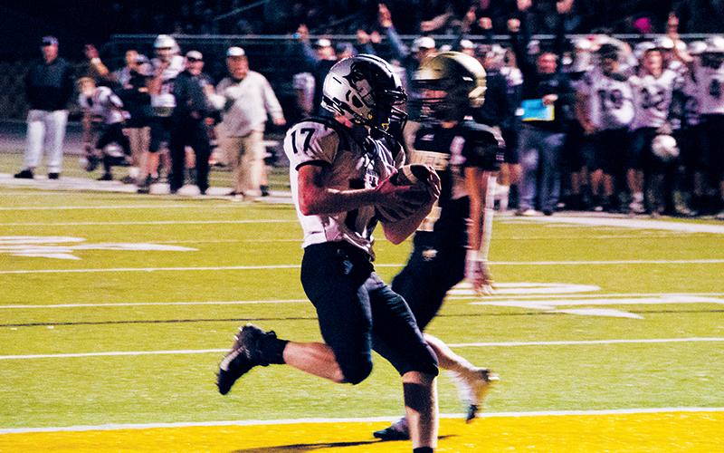 Robbinsville’s sideline rises up for Cooper Adams’ rushing touchdown late in Friday’s away game in Hayesville. His touchdown ensured that the Knights vanquished the Yellow Jackets and received a No. 8 postseason seed in the process.