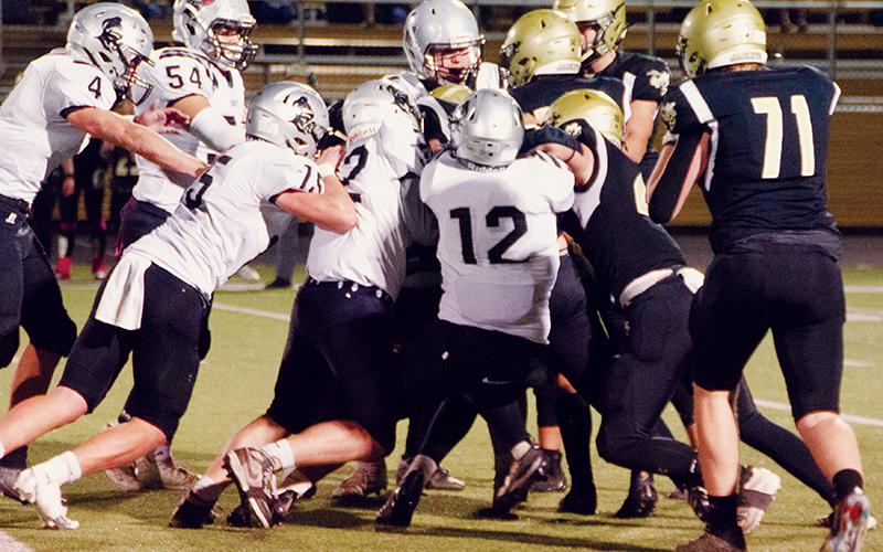 The Black Knights’ defense – led by Haden Key, Quinn Jumper, Jude Campbell, Roman Jones, Cuttler Adams and Carlos Lopez (clockwise from center) – swarm Hayesville’s Taylor McClure to stuff the Jackets’ top running threat Friday. Robbinsville held Hayesville to just 64 rushing yards on the night. Photos by Kevin Hensley/sports@grahamstar.com