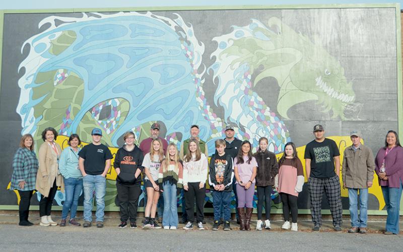 Participants in a summer art program at Robbinsville Middle School proudly stand with Graham County Schools’ faculty and staff Nov. 3, in front of a new mural that recently debuted on the side of a local shopping center. Photos by Kevin Hensley/editor@grahamstar.com