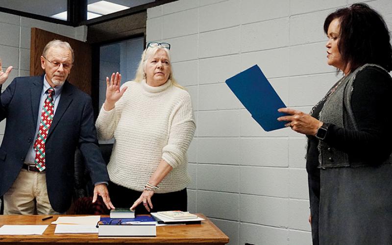 Clark “Chip” Carringer and Debra “Hank” Dinschel recite oaths of office administered by Graham County Clerk of Court Tammy Holloway at a special-called meeting of the Graham County Board of Education on Tuesday evening. Photo by Randy Foster/news@grahamstar.com