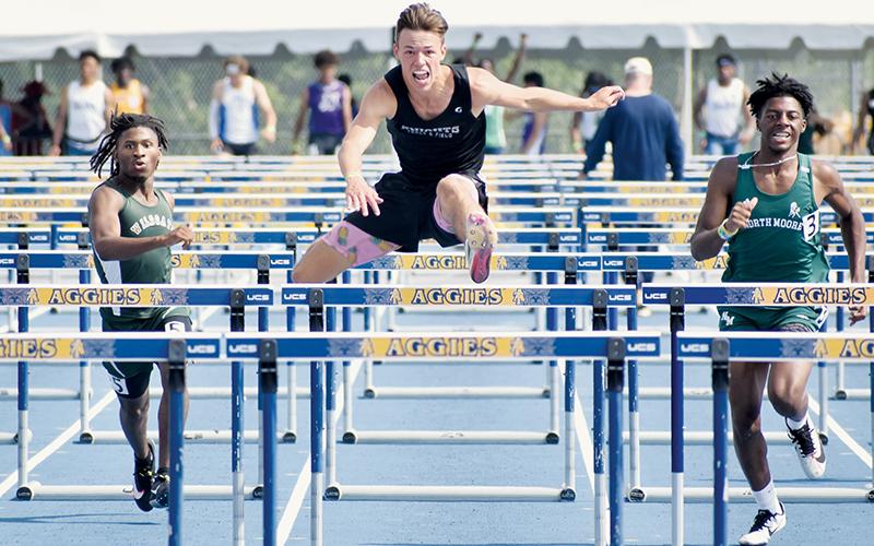 Robbinsville’s Brock Adams (center) smoked the field at the 1A state track championship meet May 21, collecting gold medals in both the 110- and 300-meter hurdles. Photo by Kevin Hensley/sports@grahamstar.com