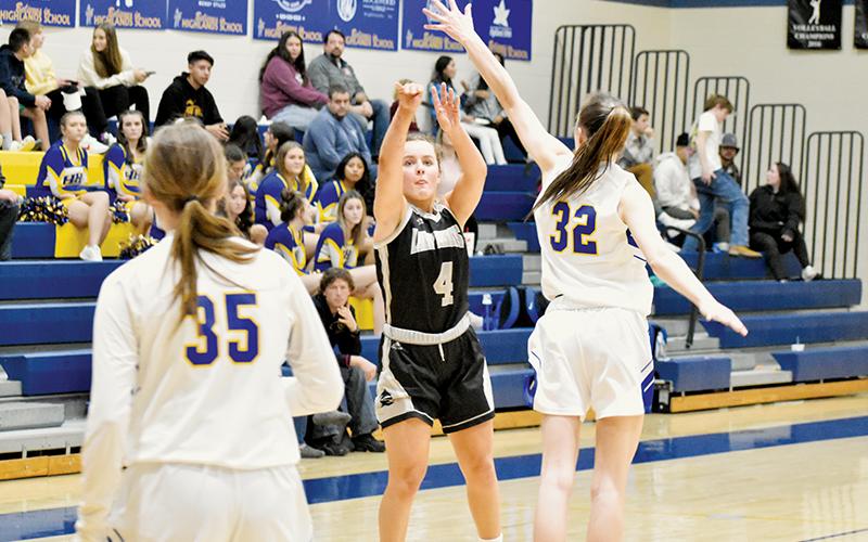 Robbinsville senior Desta Trammell launches an outside shot Monday at Highlands. Trammell hit a pair of 3-pointers in the Lady Knights’ loss to the Lady Highlanders. Photo by Kevin Hensley/sports@grahamstar.com
