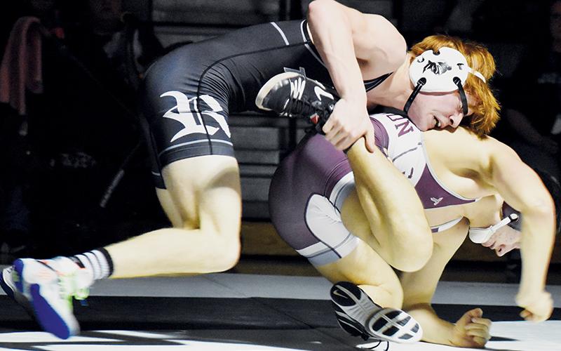 Blake Powers muscles Swain County’s Israel Ferguson in the 152-pound segment of Jan. 19’s divisional-title dual. Photo by Kevin Hensley/sports@grahamstar.com