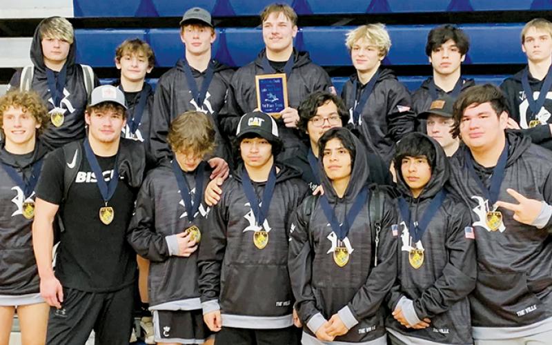 Members of the Robbinsville High School gather around the championship plaque the Black Knights  collected Saturday, after going 5-0 and winning the Enka Duals in Candler. Photo courtesy of Robbinsville Wrestling