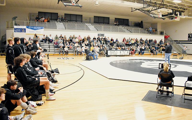 Retired Black Knights wrestling coach Todd Odom – who was over the program when Romero’s pin secured the 2017 state championship – addressed the crowd gathered for the Swain County/Robbinsville conference-title match Jan. 19. Confirmation of Romero’s passing had just taken place roughly 90 minutes before the speech was made. Photo by Kevin Hensley/sports@grahamstar.com