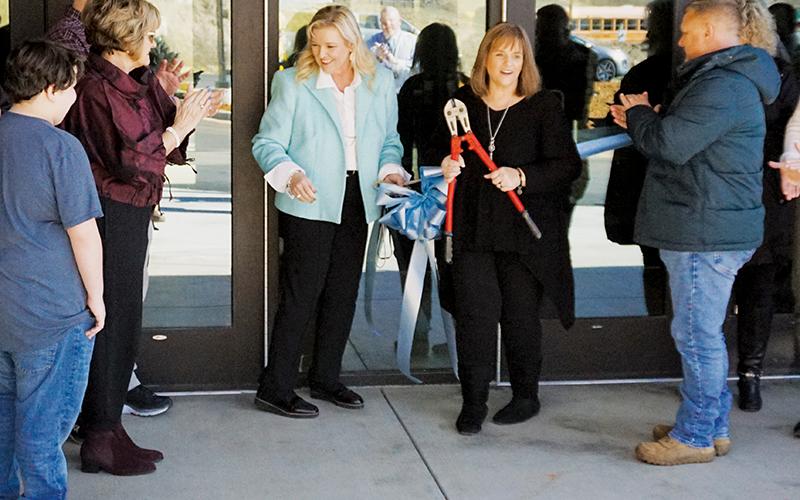 Robbinsville Middle School Principal Tonia Walsh (center left) and Graham County Schools Superintendent Angie Knight finish cutting the ribbon to unveil the new middle school expansion on Tuesday.