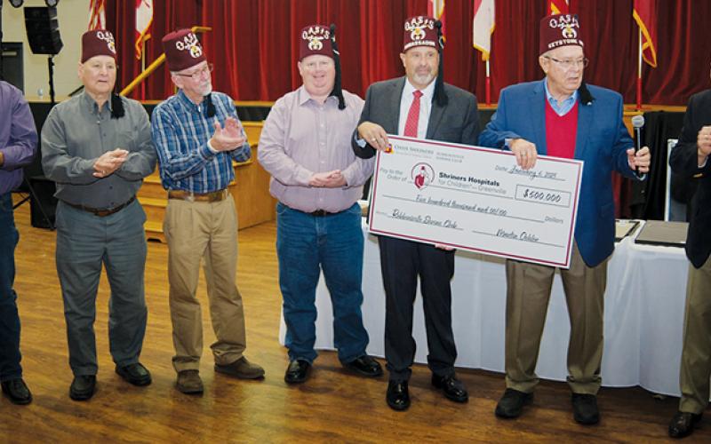Robbinsville Shriner Martin Oehler is joined by members of the Robbinsville Shriner’s Club, as news of his generous contribution is announced at Oasis Shriners Headquarters in Charlotte on Jan. 6. From left are Robert Britton, Treasurer; Billy Clark, Past President; Jack Long, President; Leon Allen, Secretary; Keith “Beefy” Rogers, Oehler and Jerry Gantt, former CEO of Shriners International and current Chairman of the Board of Trustees for Shriners Children’s. Photo courtesy of Mike Harding/Genesis Photog