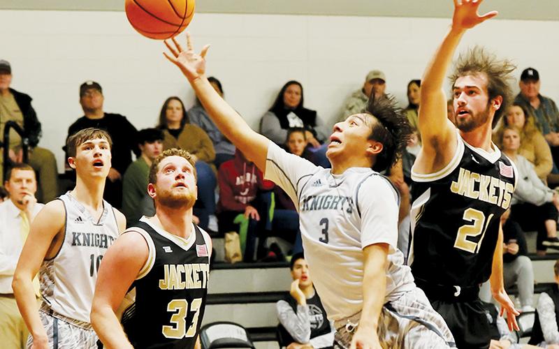 Xander Wachacha (3) evades the defense of Hayesville’s Cade Denton for a second-half floater against the Jackets on Friday. Photo courtesy of Miranda Buchanan/Robbinsville High School Yearbook