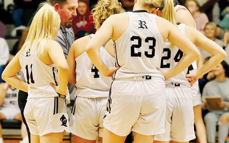 Lady Knights head coach Lucas Ford goes over some final instructions just before tip-off Friday against Hayesville, with his starting line-up (from left): Suri Watty, Desta Trammell, Liz Carpenter, Kensley Phillips and Aubrie Wachacha. Robbinsville will enter the Smoky Mountain Conference tournament at Andrews with a No. 2 seed. Photo courtesy of Miranda Buchanan/Robbinsville High School Yearbook