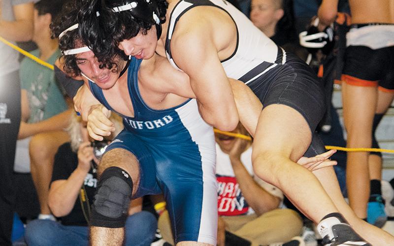 Crucial performances from grapplers like Juan Rios – shown wrangling Bradford Preparatory Academy’s Laith Hatamleh to the mat Saturday – were instrumental in Robbinsville’s regional-title victory. Photo courtesy of Anna Riddle/Contributing Photographer