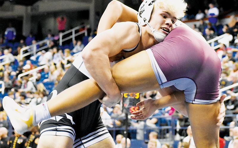 Kage Williams grabs a single-leg on Swain County’s Darius Saunooke during Saturday’s 182-pound state finals. Williams went on to win his second title at 182.